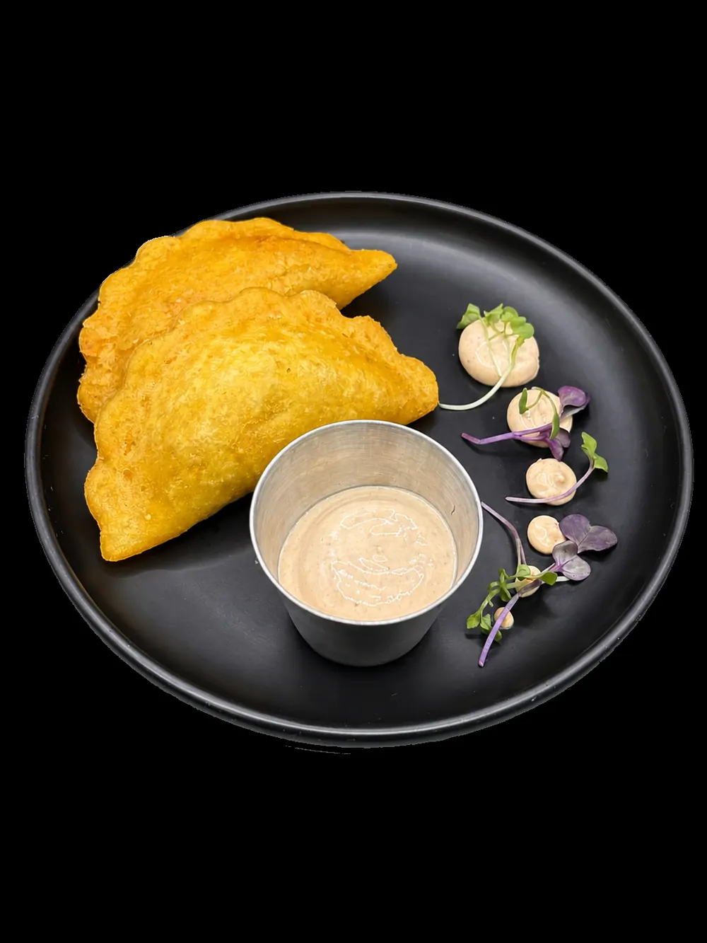 Golden Los Primos empanadas served with house sauce